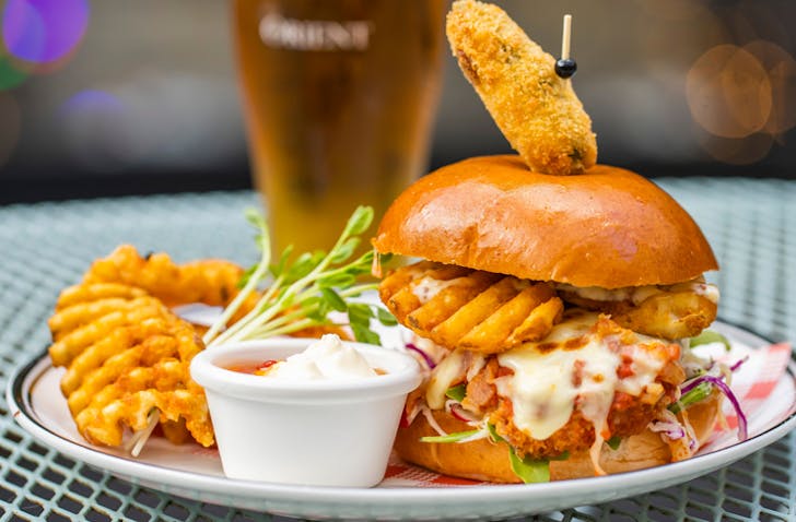 parmi burger at pub with schooner of beer