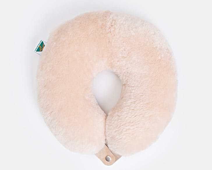 a pale pink fluffy neck pillow.