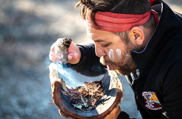 man blowing smoke on bark