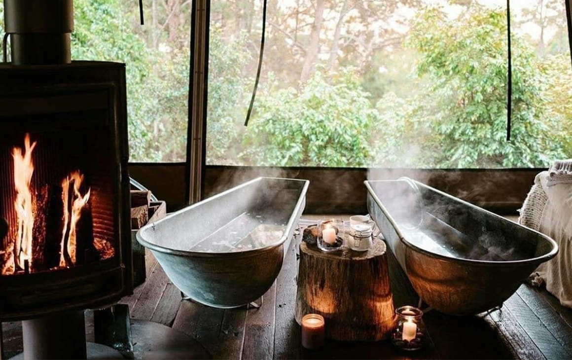 2 steaming baths next to a fire place 