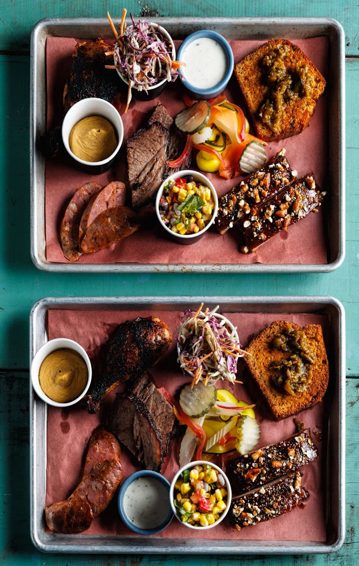 platter of slow cooked meats with sides from nola meathouse