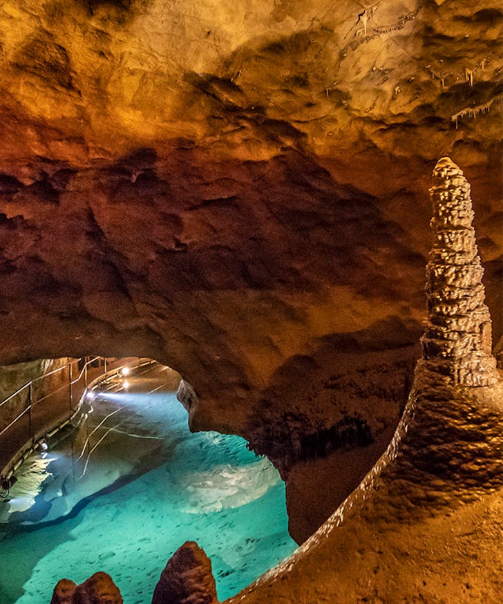 A bright blue pool of water inside the Jenolan Caves