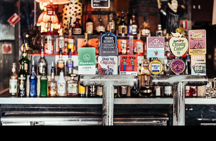 front bar of sydney's iconic oxford tavern featuring beer taps and bottles of spirits
