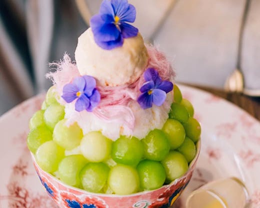 big bowl of bingsu with frozen fruit bowls and ice cream 