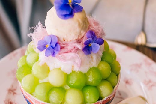 big bowl of bingsu with frozen fruit bowls and ice cream