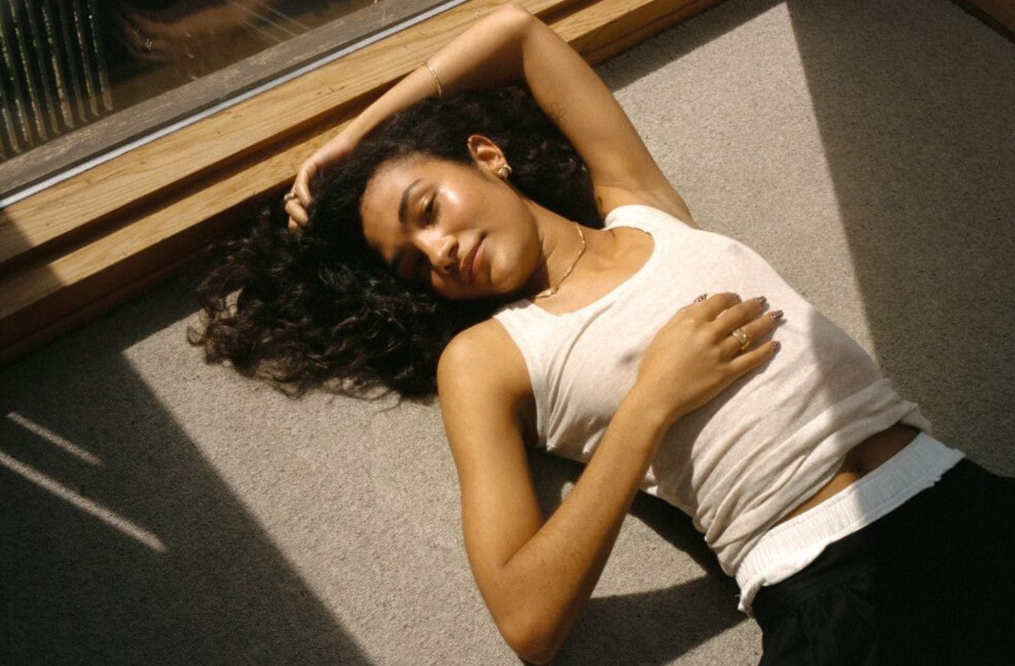 a person lying on the ground, posing for camera