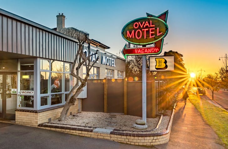 motel neon sign outside motel at sunset