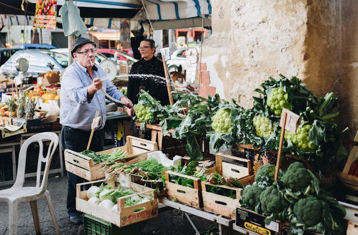 a person standing at a market stall in the street
