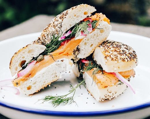 cream cheese and salmon bagel on rustic plate
