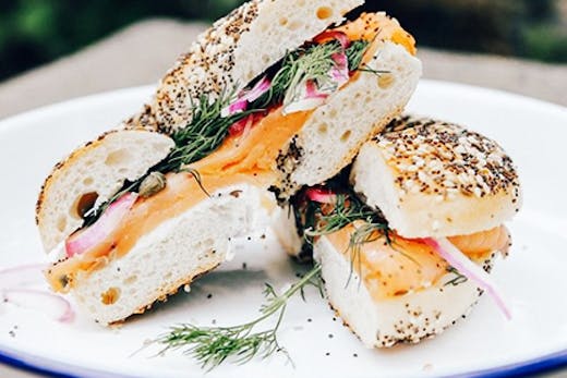 cream cheese and salmon bagel on rustic plate