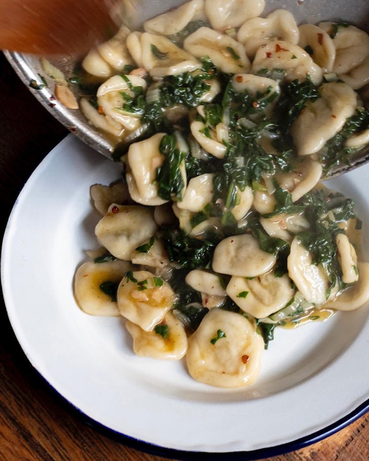 Pasta pouring into a serving dish at Pici in Auckland. 