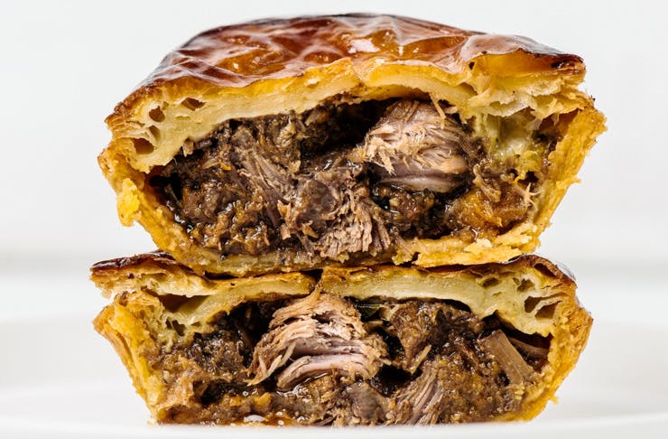 juicy meat pie cut in half and stacked