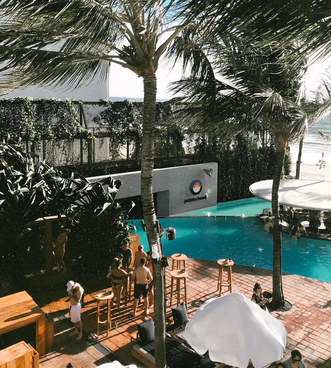 a resort pool in bali surrounded by palm trees