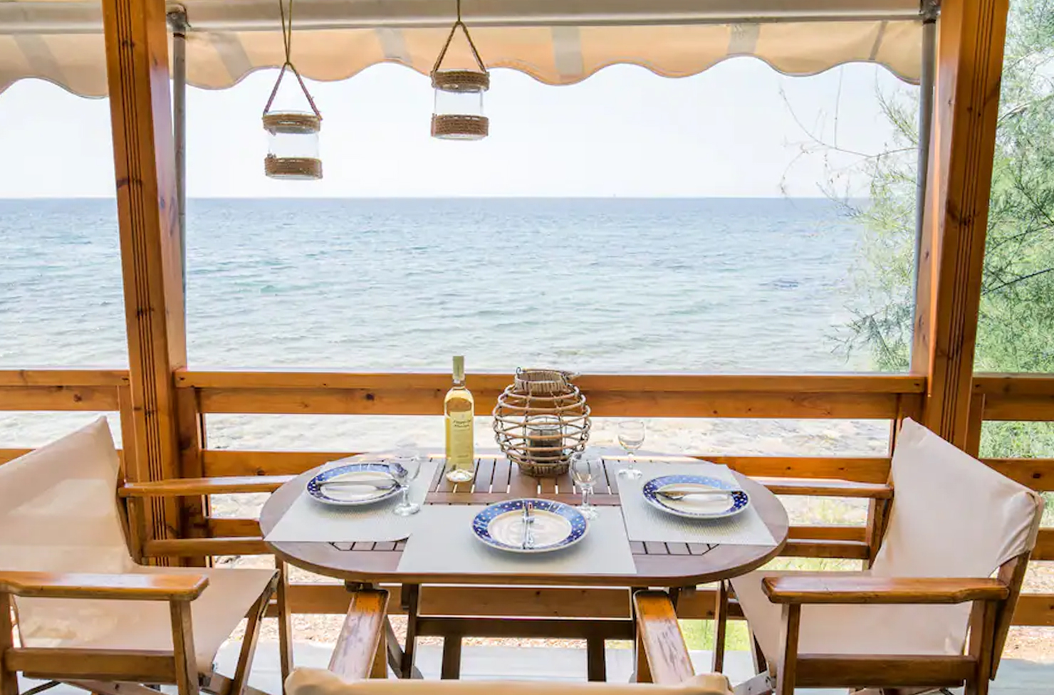a table and chair set up on a patio overlooking the water