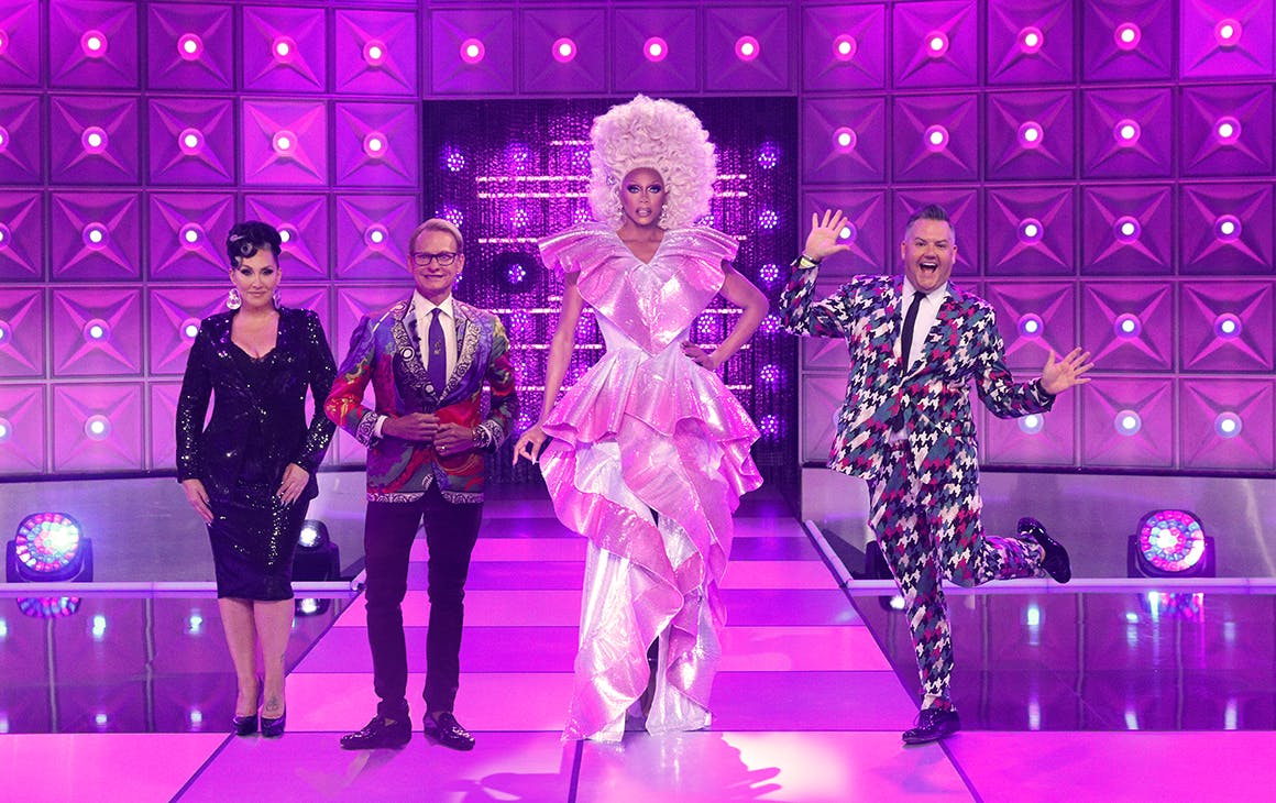 Rupaul and their fellow judges pose on a purple stage