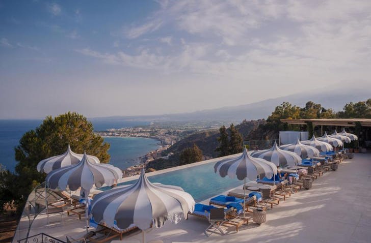 an infinity pool with umbrellas