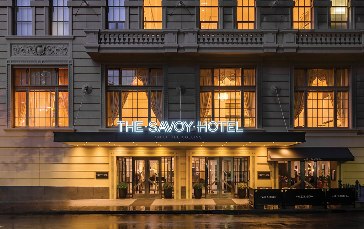 the heritage exterior of the savoy in melbourne at night
