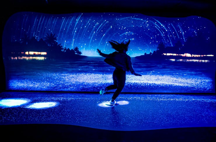person standing in neon lit room