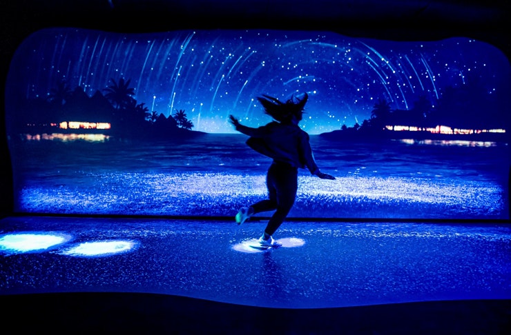 person standing in neon lit room