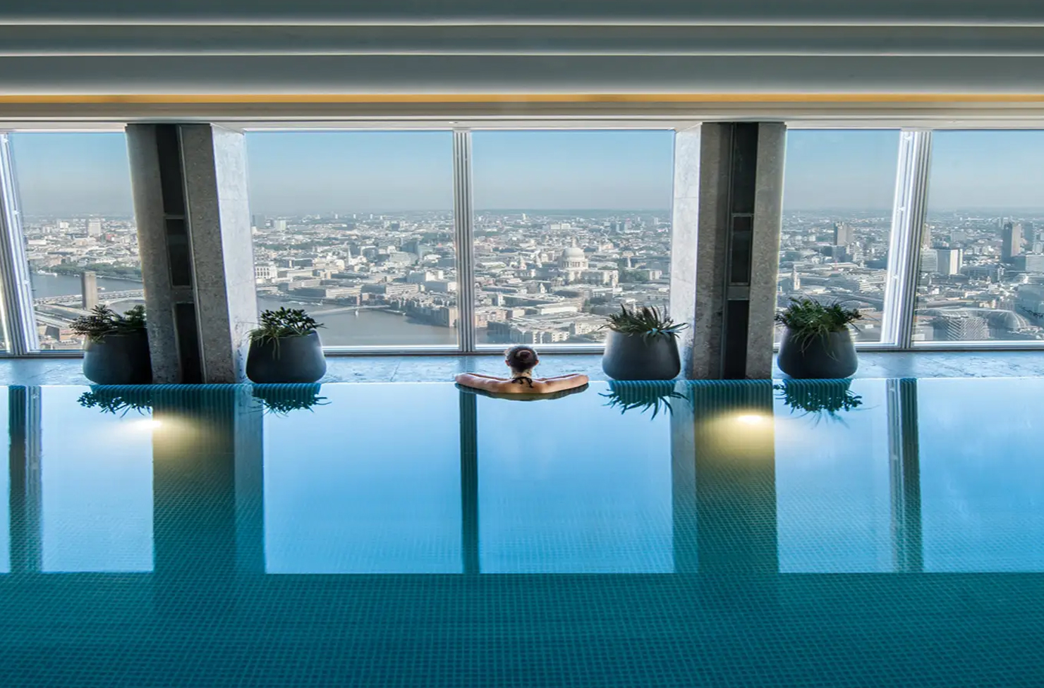 a person in a pool overlooking london
