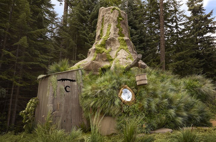 an outhouse built into a tree