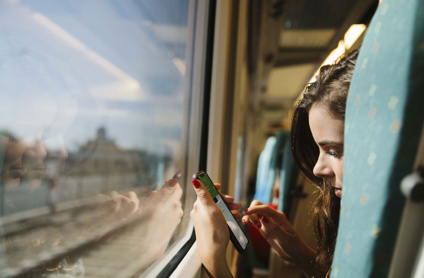 a person on their phone on a train