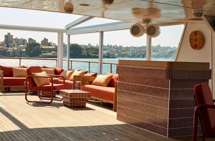 tables and chairs on the second level of a superyacht