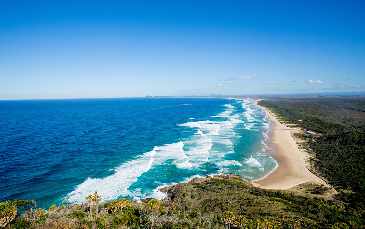 coastline on a sunny day with waves crashing 