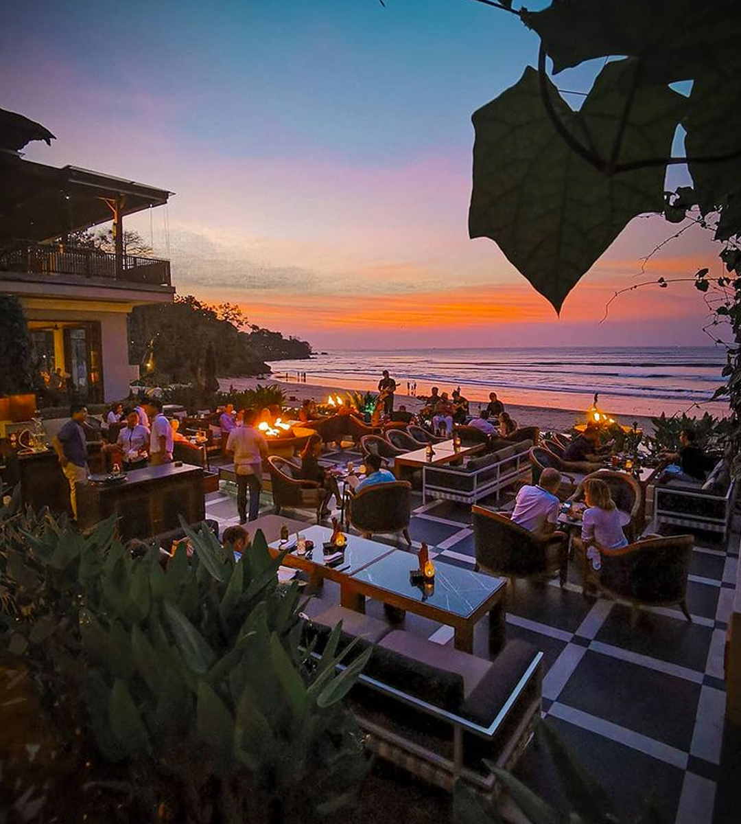 people dining on a patio at sunset