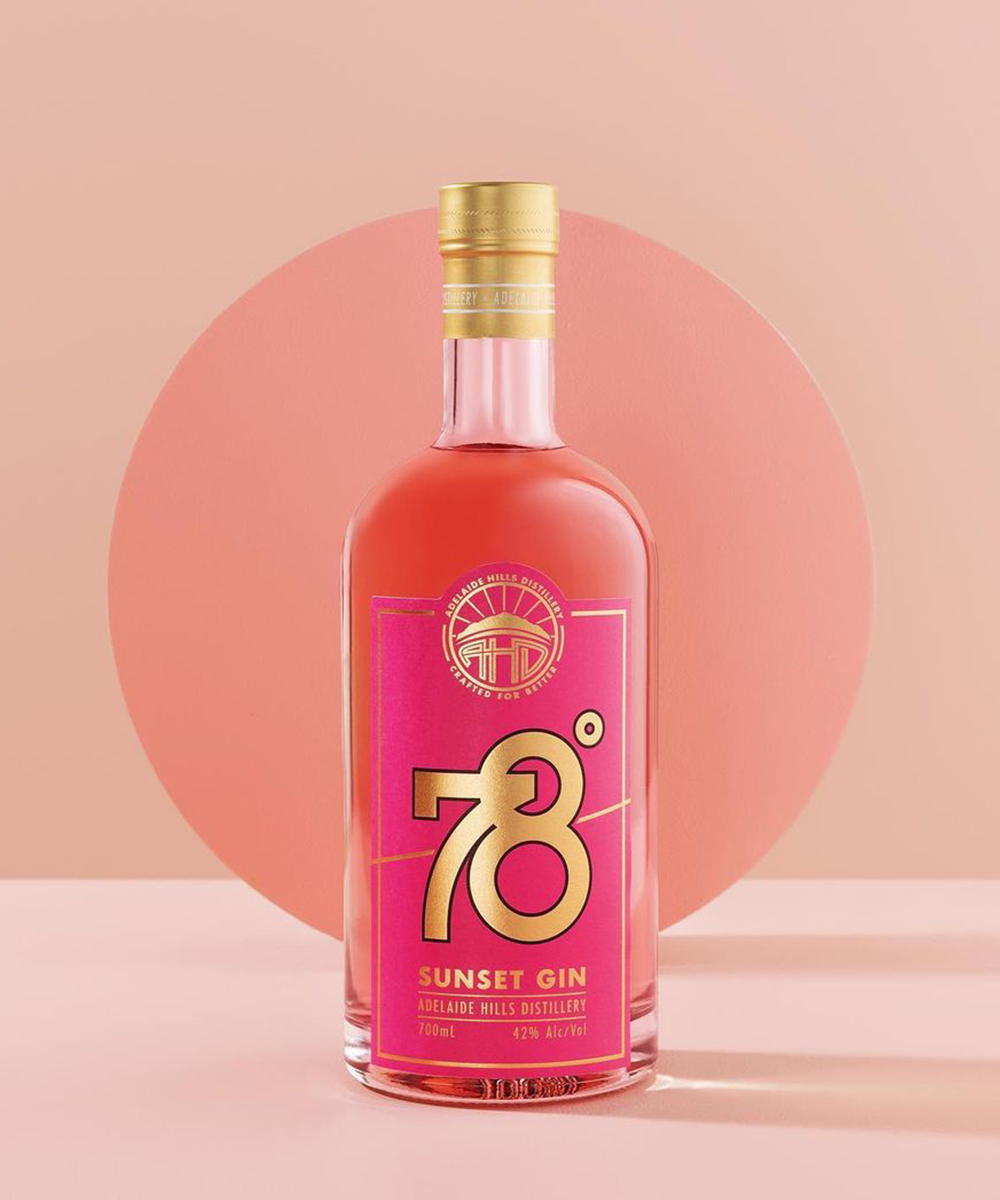 a pink glass bottle on a pink background