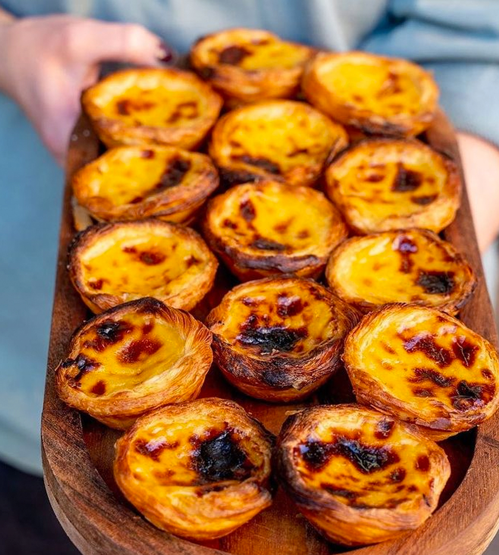 wooden tray of portuguese tarts