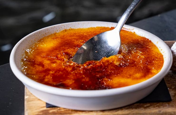 creme brulee with spoon in it