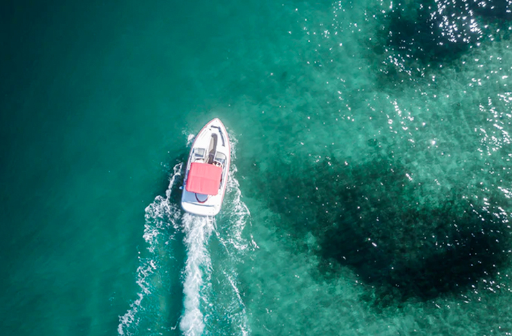 boat speeding away in water