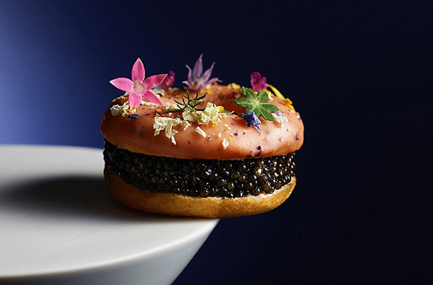 a doughnut burger with caviar