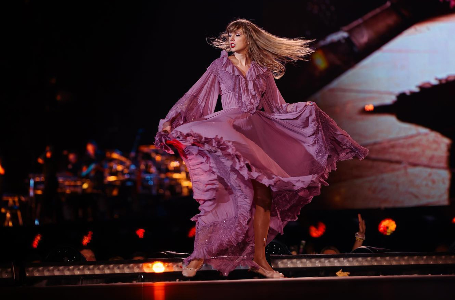 a person wearing a flowing dress on stage