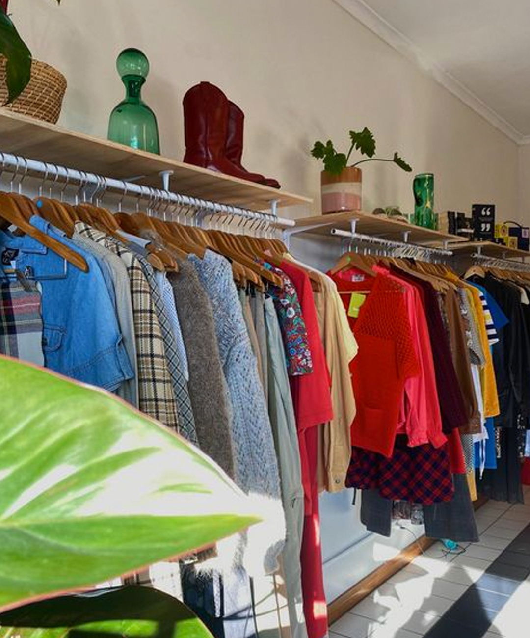 second hand clothes hanging up in an op shop