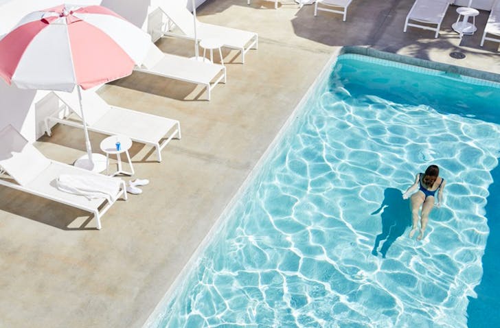 girl swimming in clear pool at motel