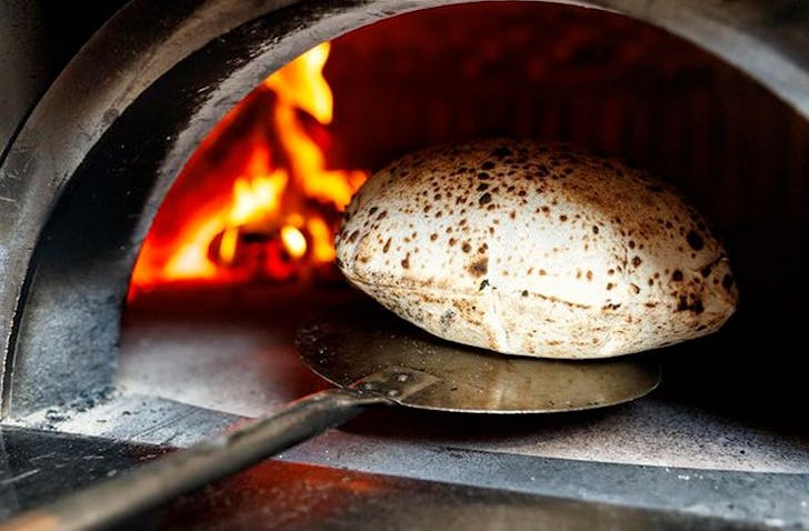 wood fired bread coming out of the oven