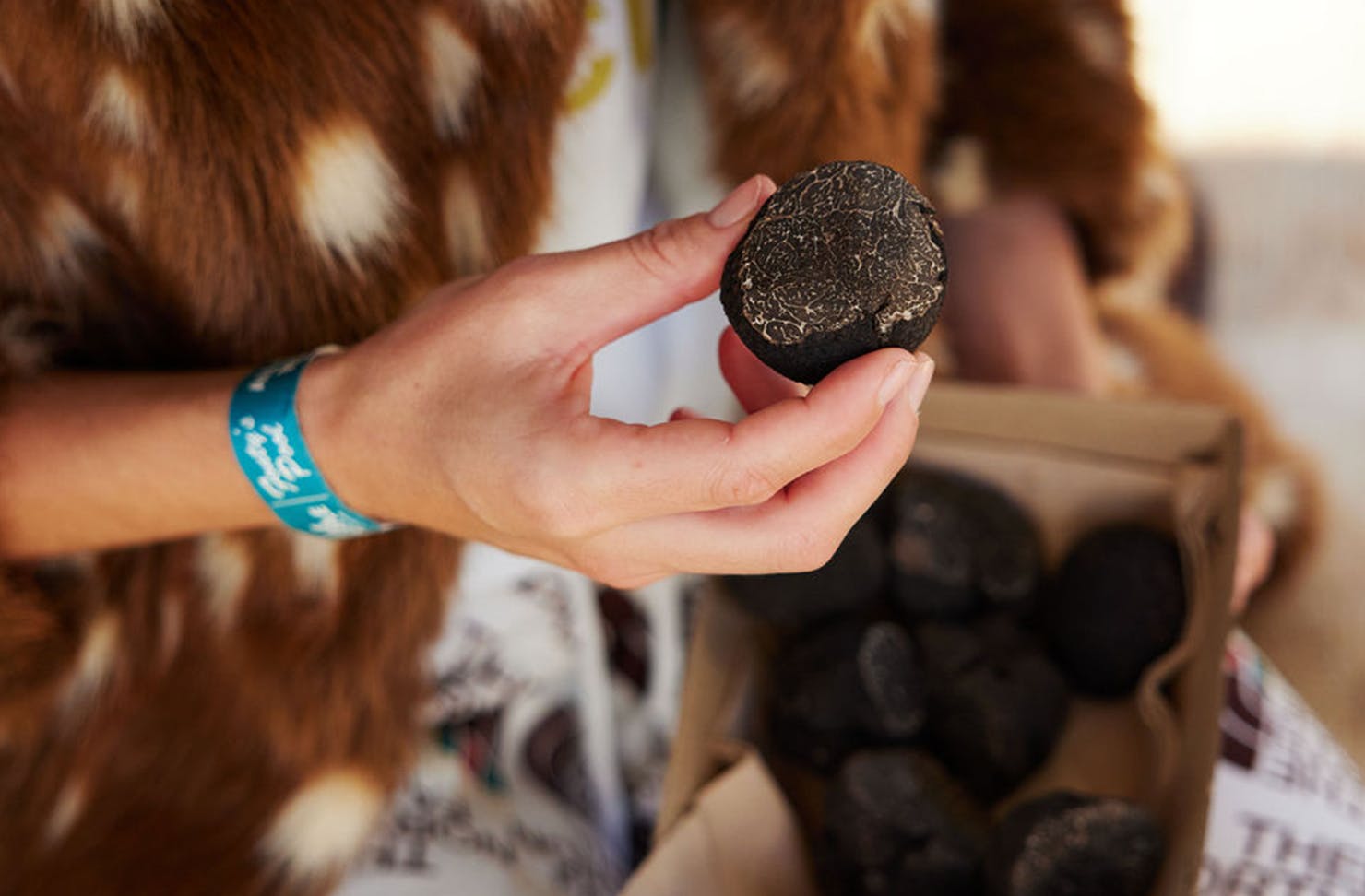 Woman holding a truffle at Truffle Kerfuffle.