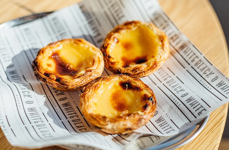 three portuguese tarts on a plate