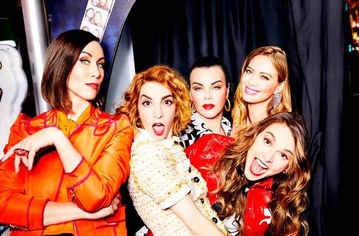 the cast of Younger cuddle up to each other in a photo booth, pulling funny faces