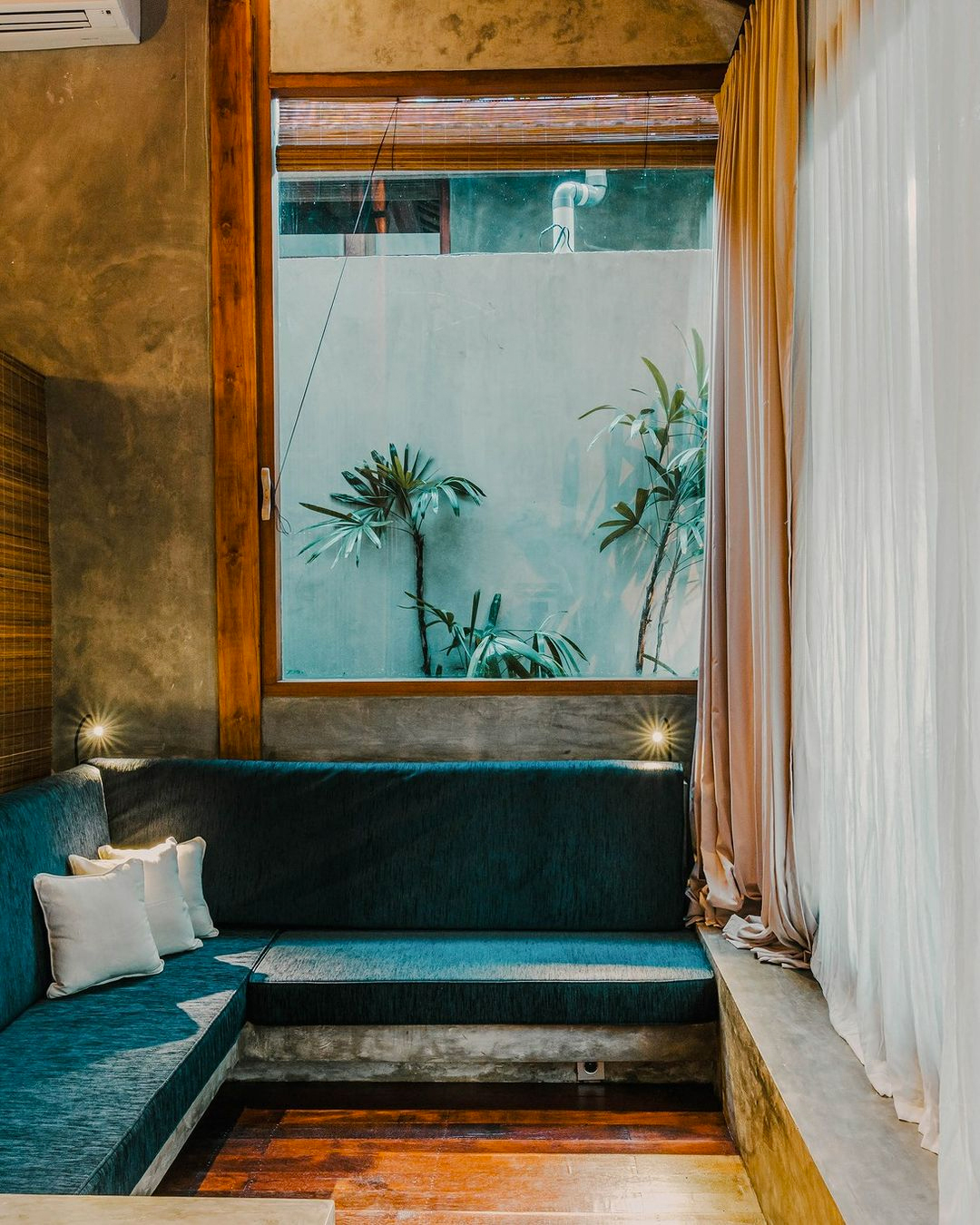 a window lounge at a hotel overlooking the pool